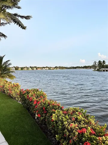 a view of a lake with a house in the background