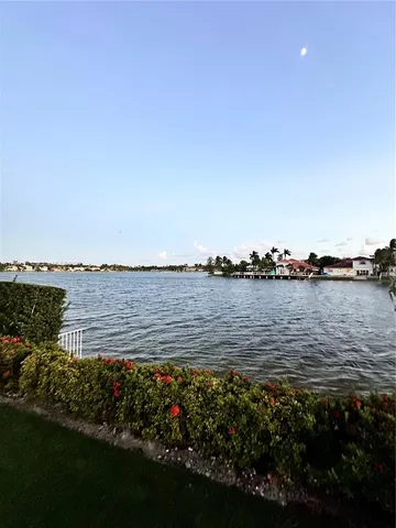 a view of a large body of water with a building in the background