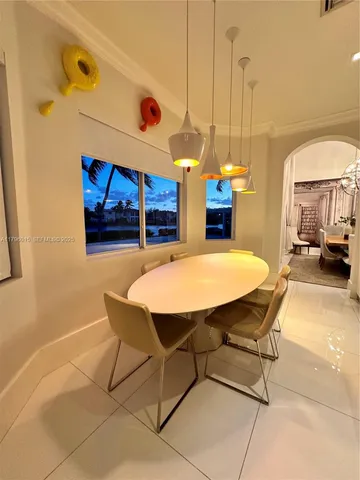 a view of a dining room with furniture one side and a windows