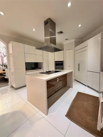 a kitchen with stainless steel appliances a refrigerator and a stove top oven