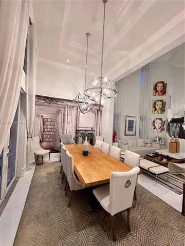 a living room with furniture a rug and a chandelier