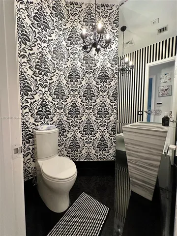 a bathroom with a toilet and a shower curtain
