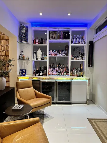 a living room with stainless steel appliances kitchen island granite countertop furniture and a view of kitchen