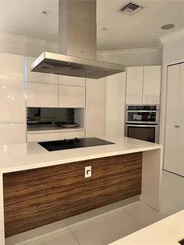 a kitchen with stainless steel appliances granite countertop a sink a stove and a microwave