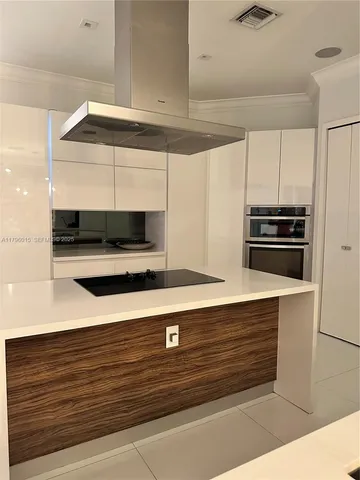 a kitchen with stainless steel appliances granite countertop a sink a stove and a microwave