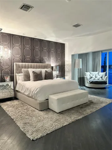a large bedroom with a bed and couch