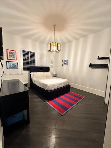 a bedroom with a bed and a table