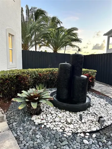 a view of a backyard with plants and patio