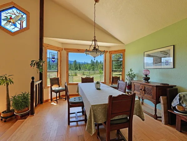 a view of a dining room with furniture window and wooden floor