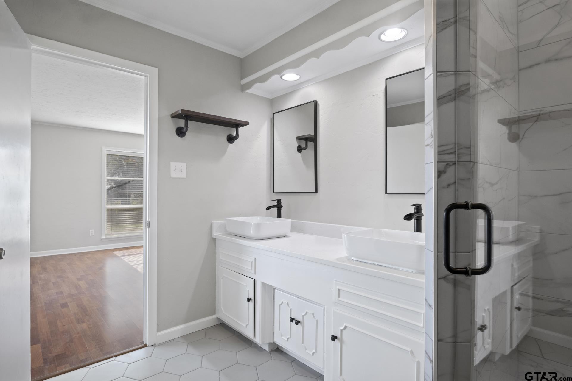331 County Road 2106 Pittsburg, TX 75686 - Photo 16 of 32 a bathroom with a double vanity sink a toilet and a mirror