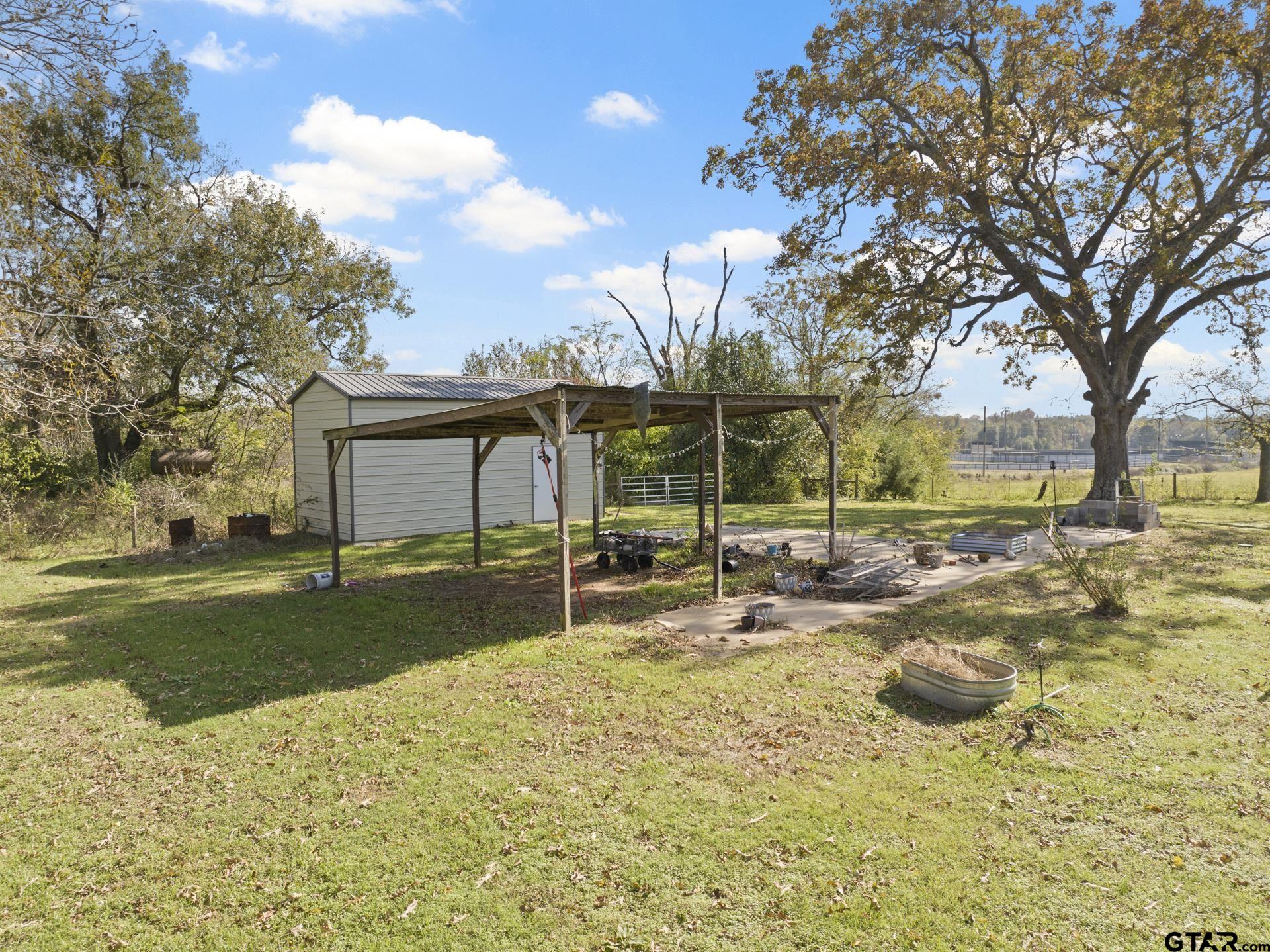 331 County Road 2106 Pittsburg, TX 75686 - Photo 20 of 32 a view of a house with backyard and sitting area