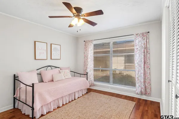 a bedroom with two beds and windows