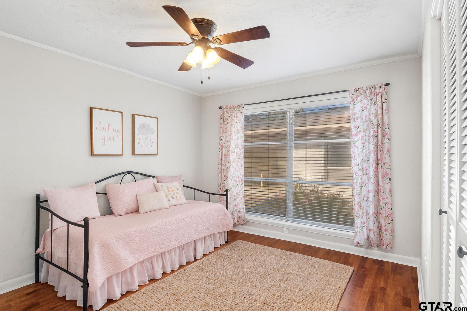 331 County Road 2106 Pittsburg, TX 75686 - Photo 27 of 32 a bedroom with a bed and a large window