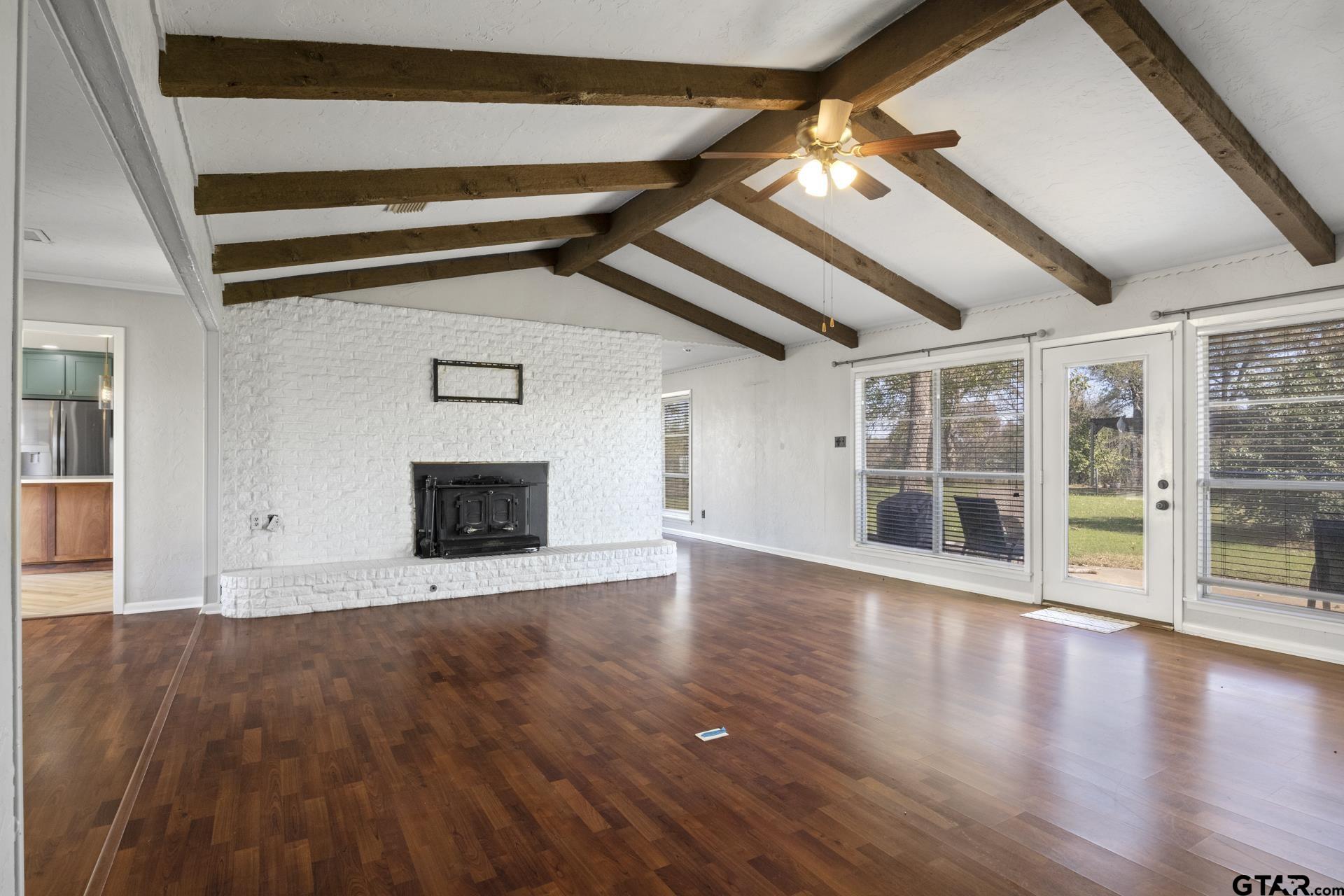 331 County Road 2106 Pittsburg, TX 75686 - Photo 4 of 32 a view of an empty room with wooden floor and a window
