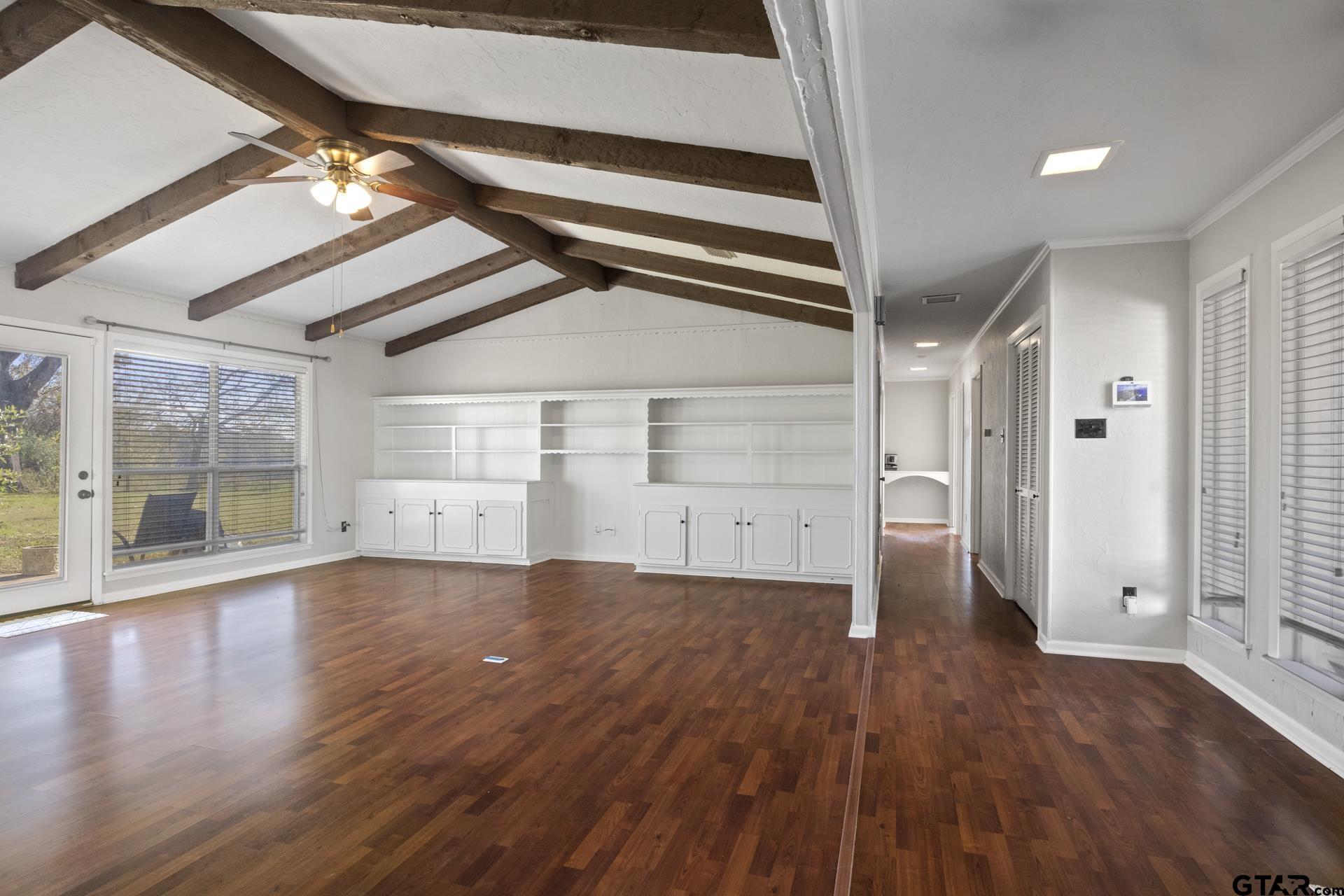 331 County Road 2106 Pittsburg, TX 75686 - Photo 5 of 32 en empty room with wooden floor and windows