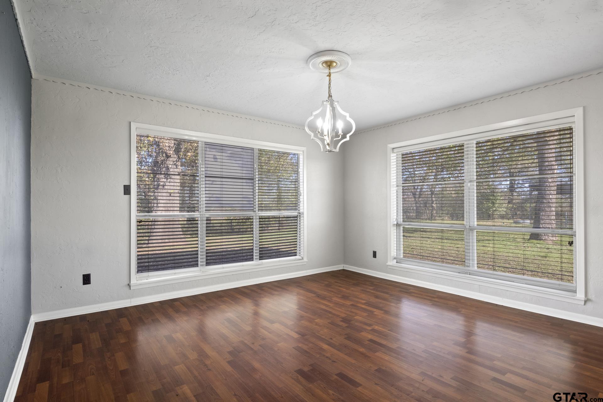 331 County Road 2106 Pittsburg, TX 75686 - Photo 6 of 32 a view of an empty room with wooden floor and a window