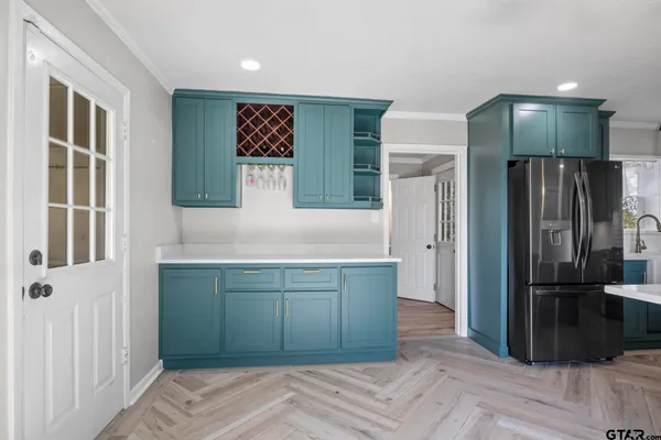 a kitchen with stainless steel appliances granite countertop a refrigerator and a sink