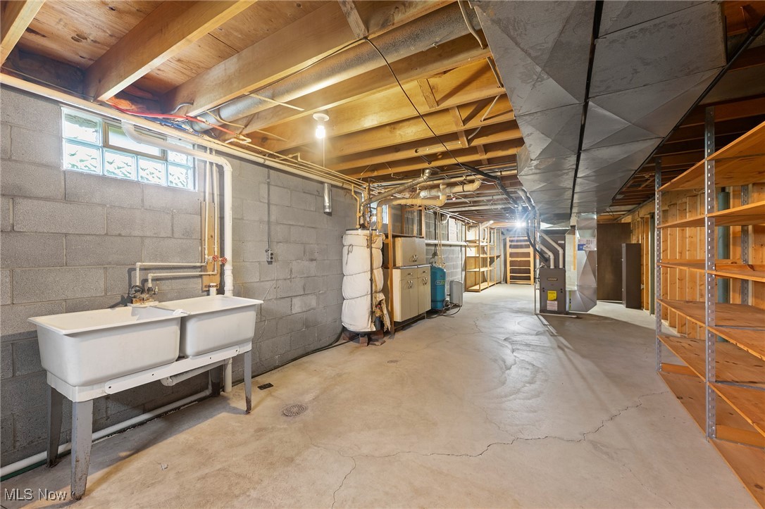744 Johnson Plank Road Warren, OH 44481 - Photo 25 of 39 Below grade area featuring stairs, heating unit, and a water pressure tank