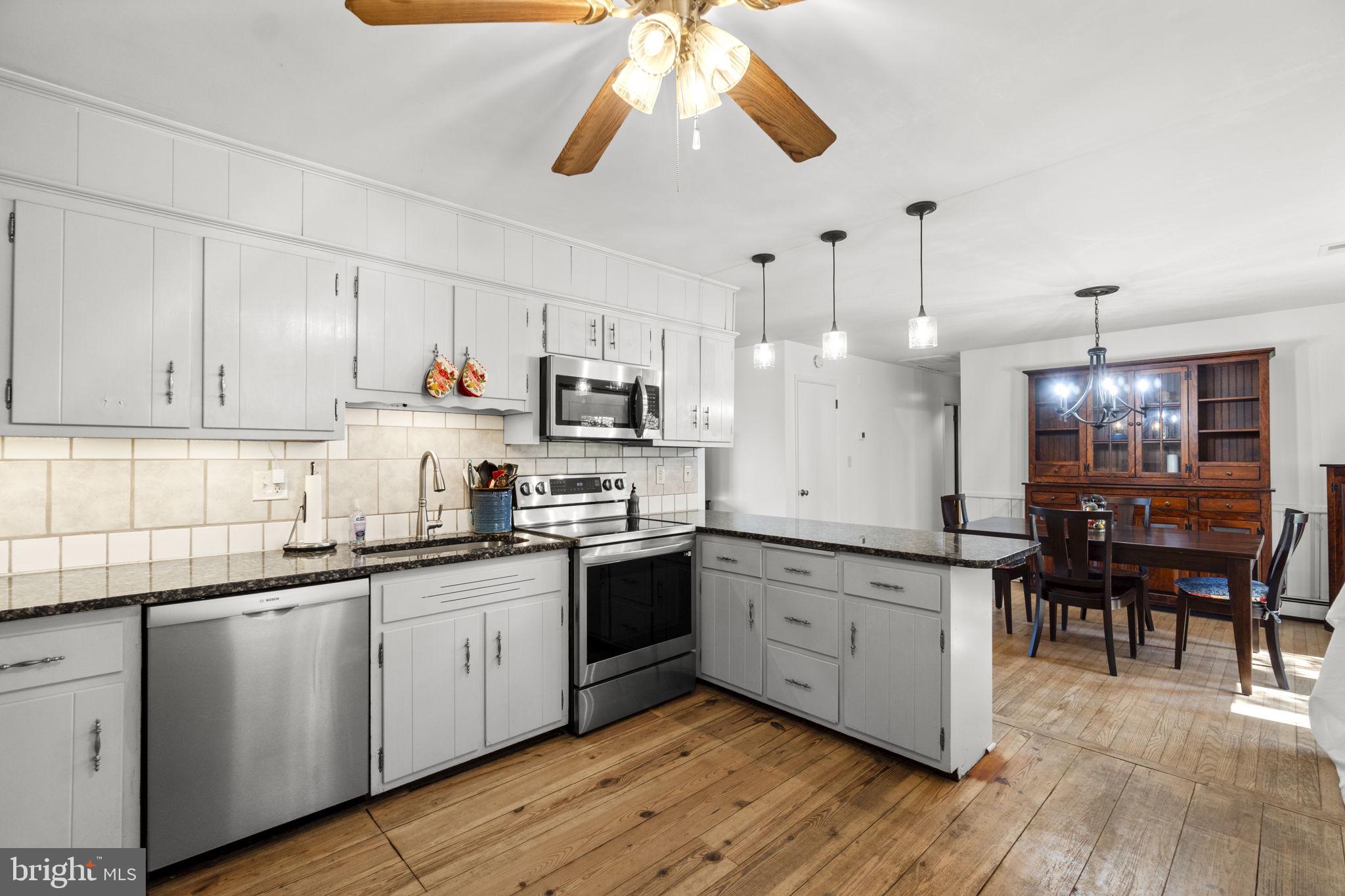 2401 Albert Rill Road Hampstead, MD 21074 - Photo 11 of 38 a kitchen with cabinets a sink a center island and appliances