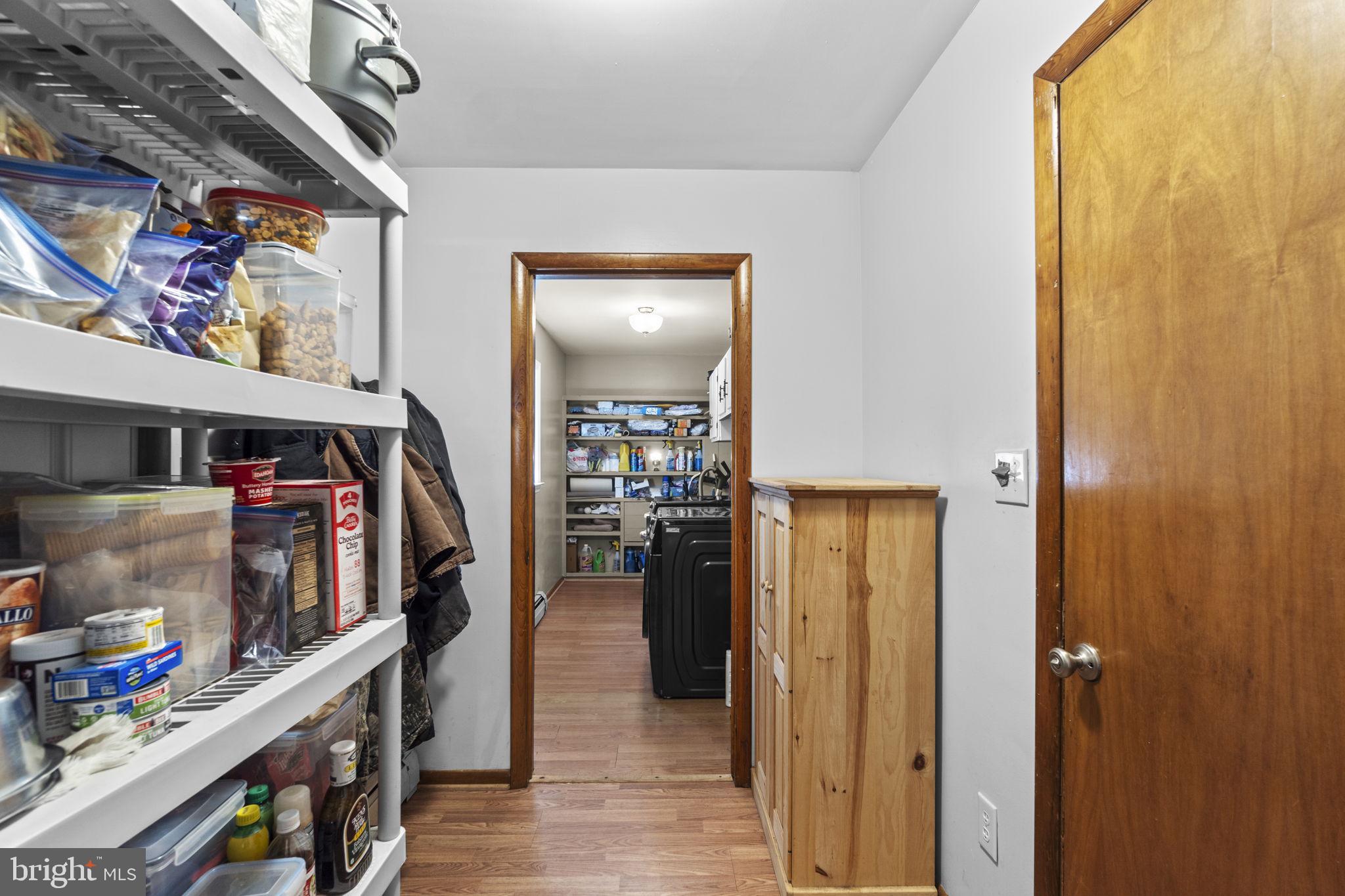 2401 Albert Rill Road Hampstead, MD 21074 - Photo 12 of 38 a view of a hallway with wooden floor and furniture