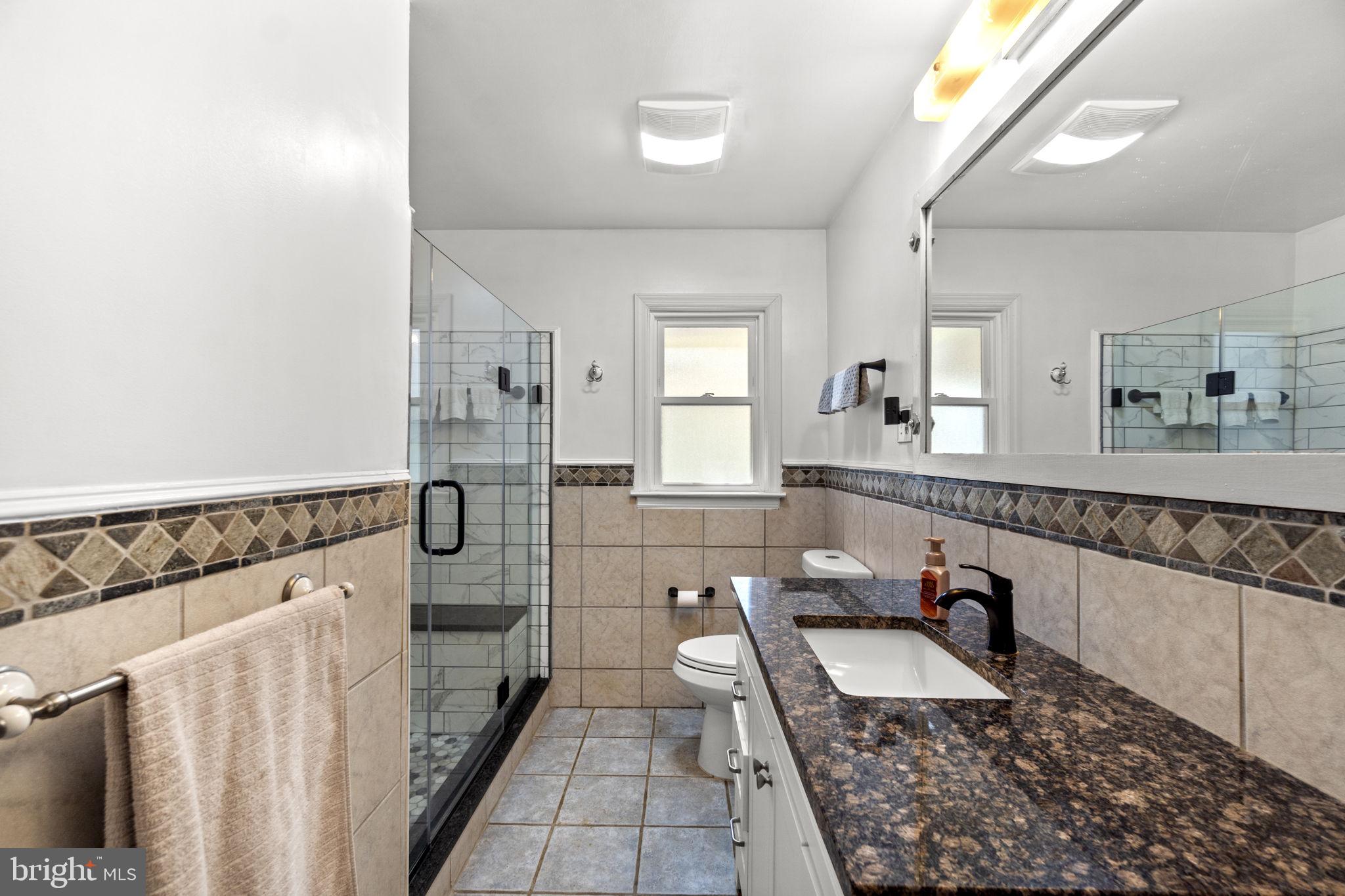 2401 Albert Rill Road Hampstead, MD 21074 - Photo 15 of 38 a bathroom with a sink a mirror and a shower