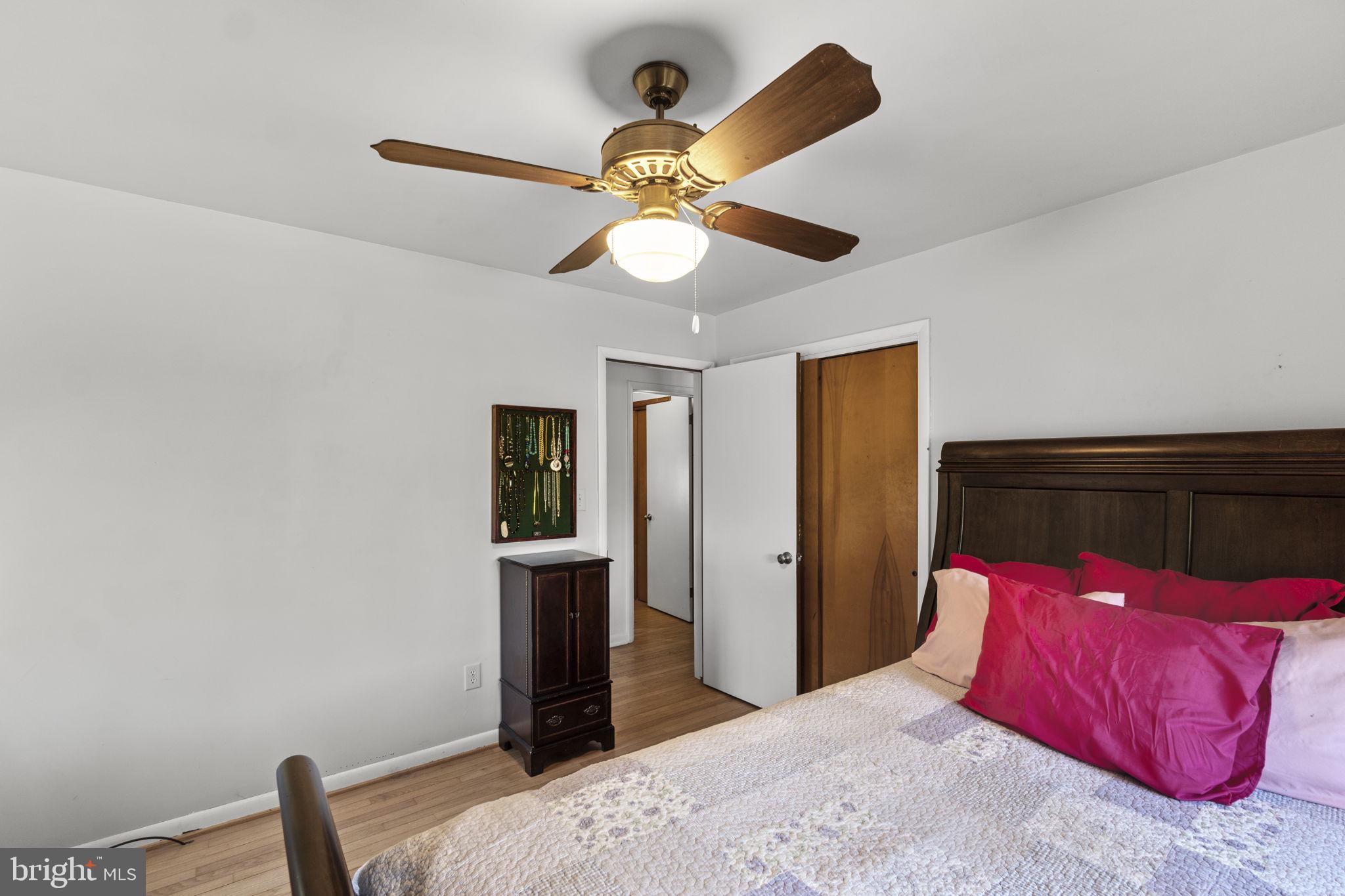 2401 Albert Rill Road Hampstead, MD 21074 - Photo 20 of 38 a bedroom with a bed and a chandelier