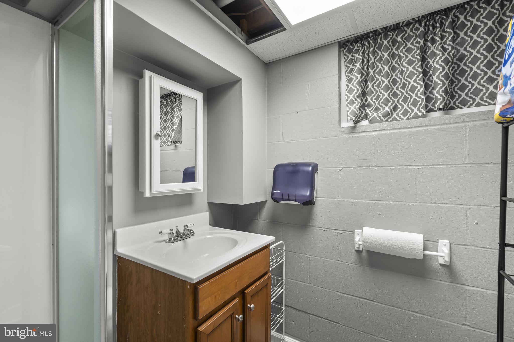 2401 Albert Rill Road Hampstead, MD 21074 - Photo 27 of 38 a bathroom with a sink a toilet and mirror