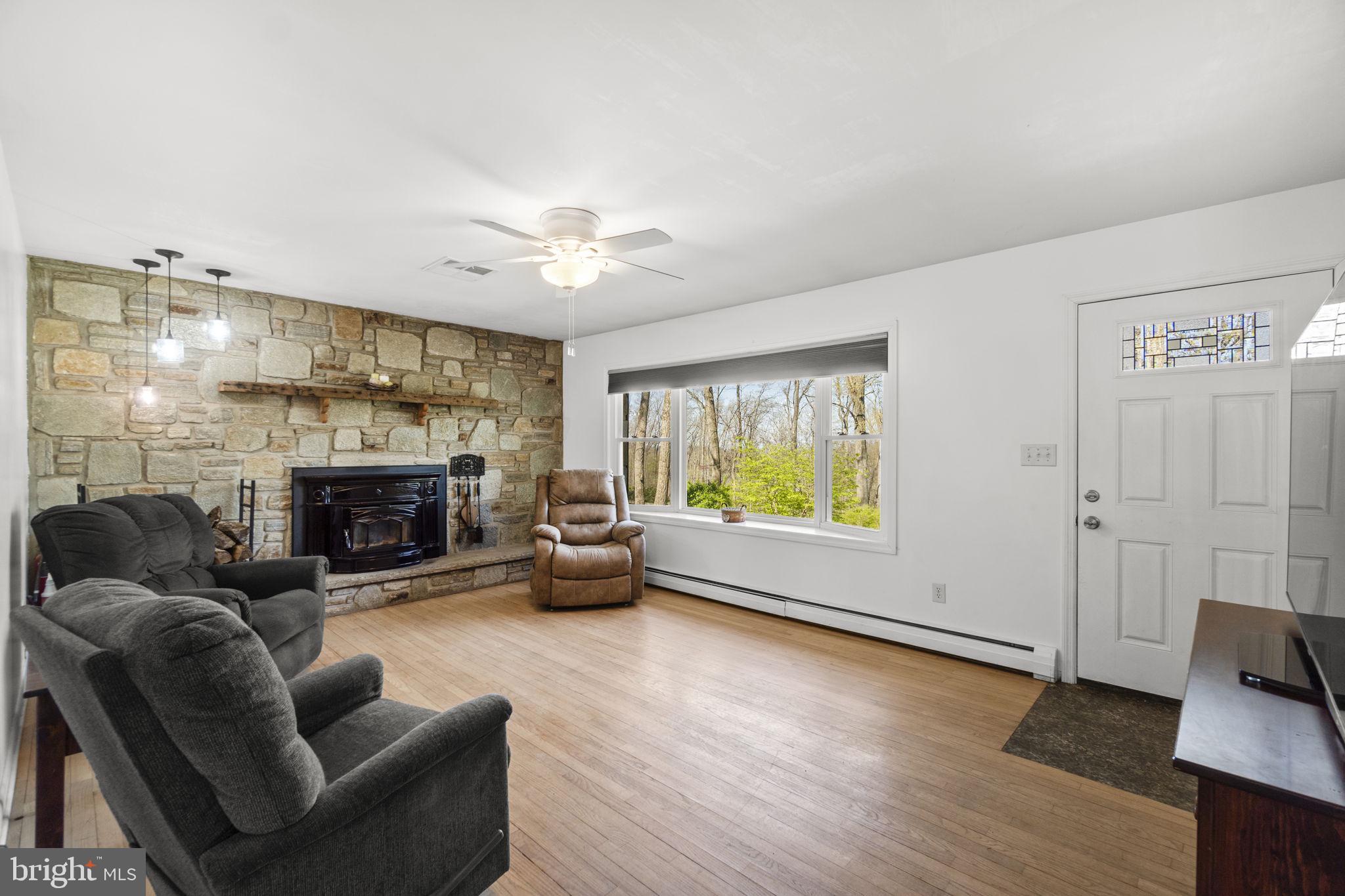 2401 Albert Rill Road Hampstead, MD 21074 - Photo 5 of 38 a living room with furniture and a fireplace