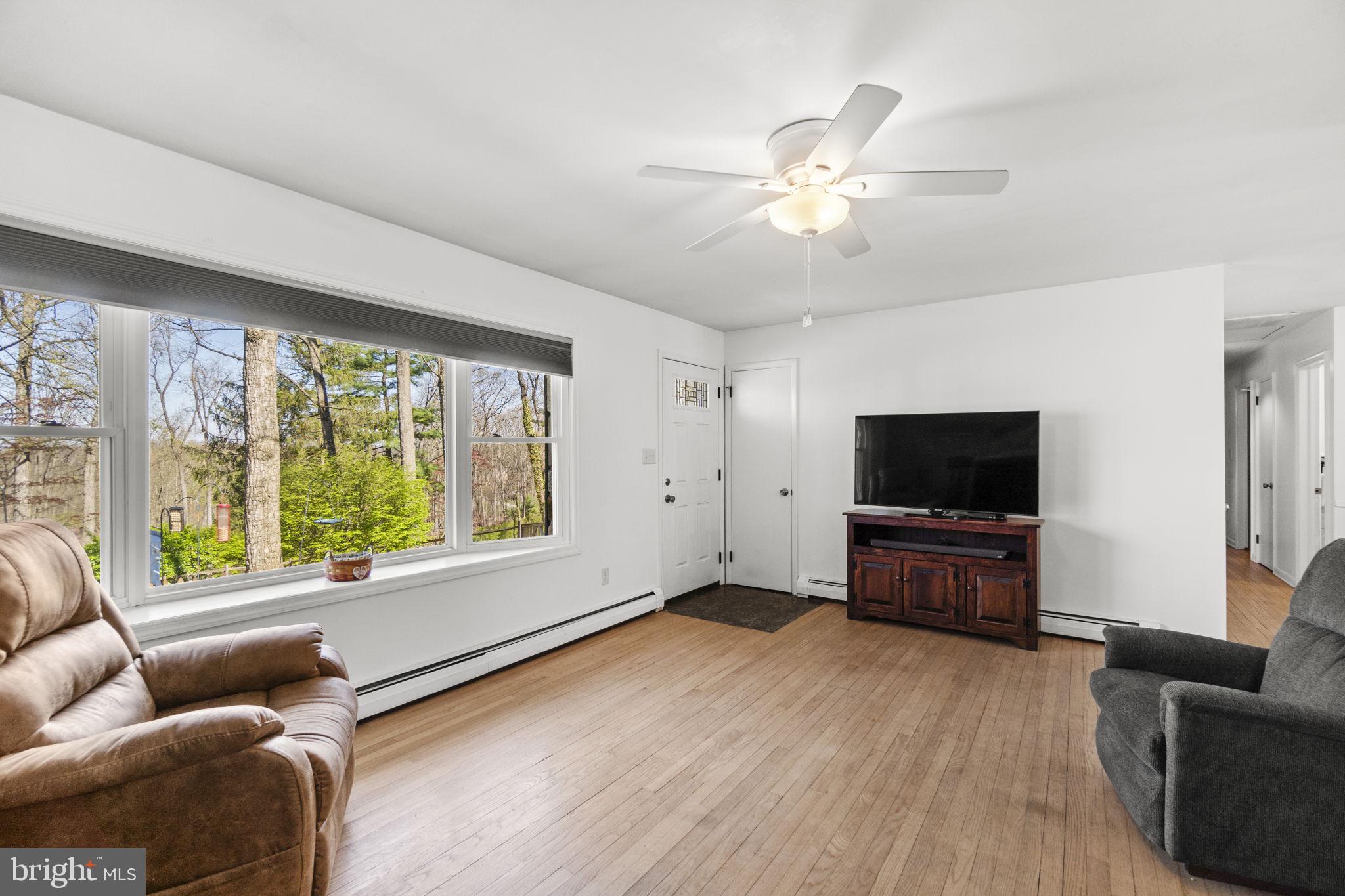 2401 Albert Rill Road Hampstead, MD 21074 - Photo 6 of 38 a living room with furniture and a flat screen tv