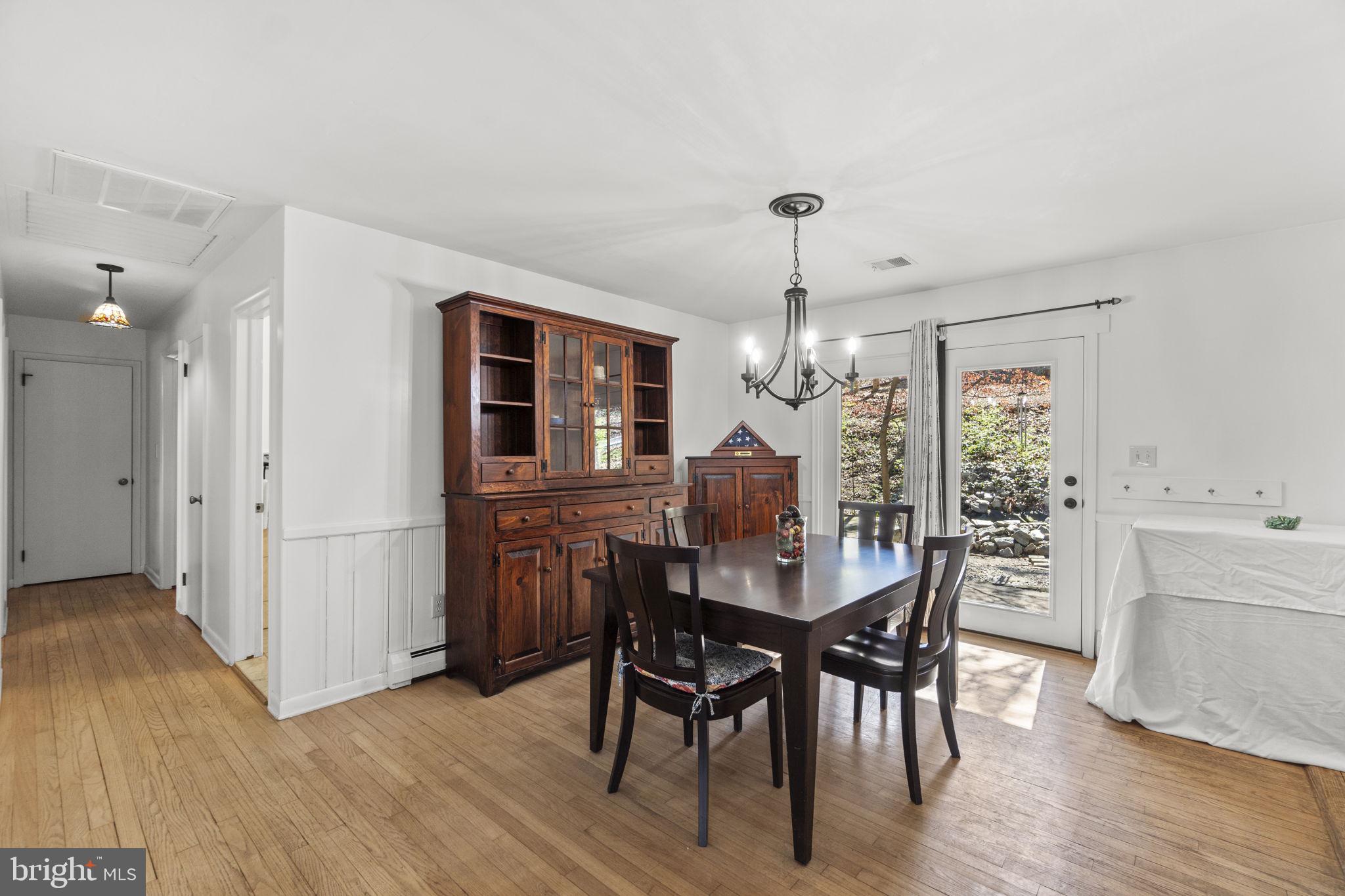2401 Albert Rill Road Hampstead, MD 21074 - Photo 7 of 38 a view of a dining room with furniture and wooden floor