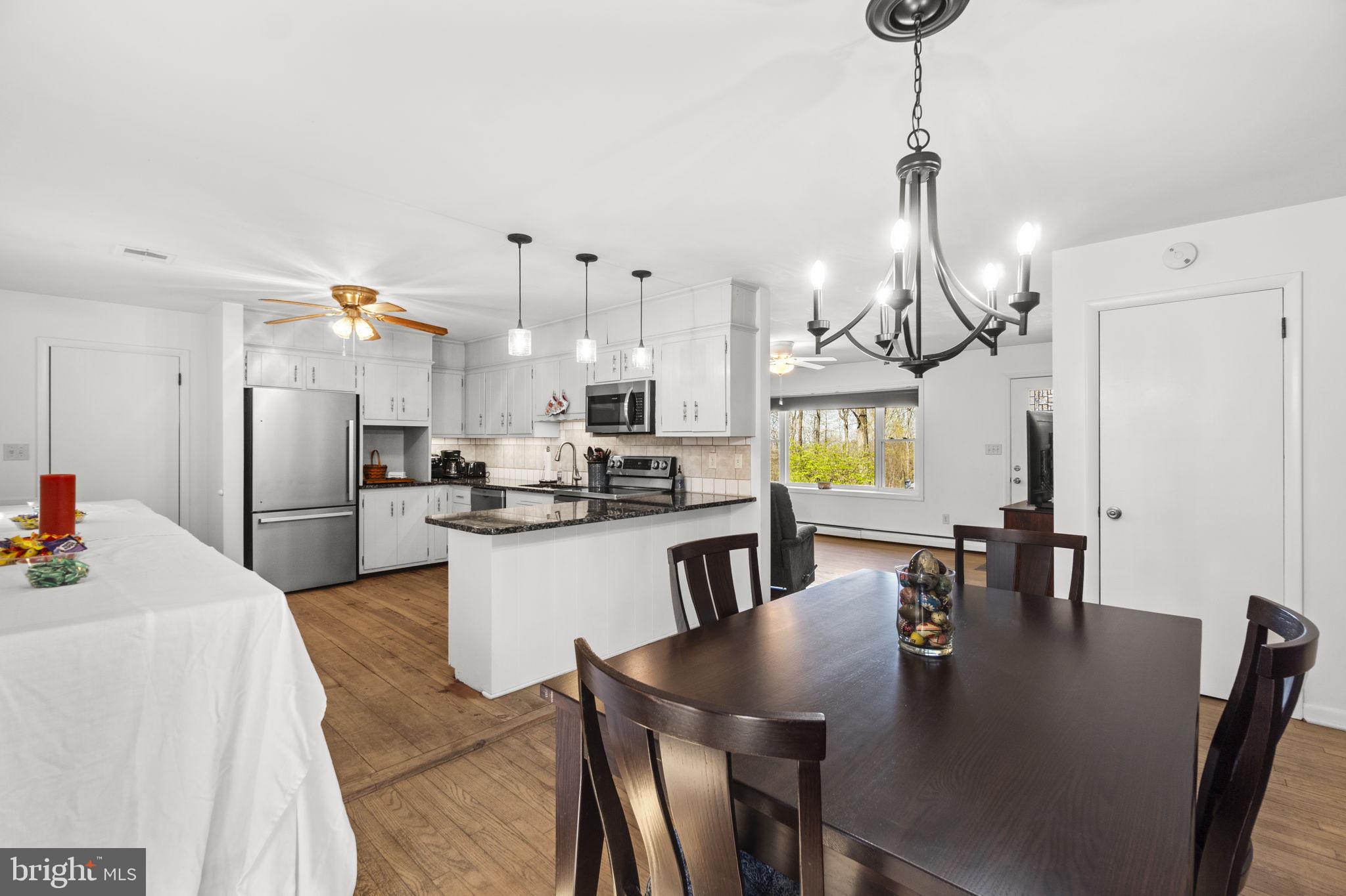 2401 Albert Rill Road Hampstead, MD 21074 - Photo 8 of 38 a kitchen with refrigerator and chairs