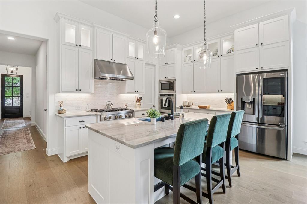 8277 Halifax The Colony, TX 75056 - Photo 10 of 37 a kitchen with cabinets stainless steel appliances and a dining table