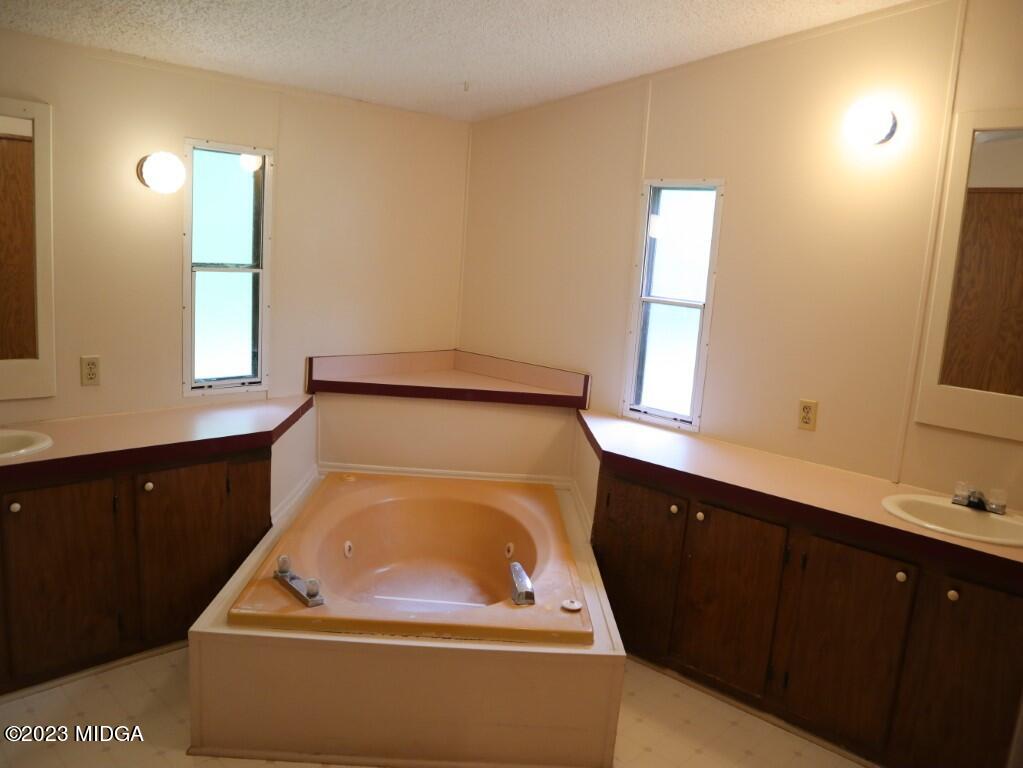 2560 Bonner Gilbert Road Lizella, GA 31052 - Photo 12 of 23 a utility room with sink dryer and window