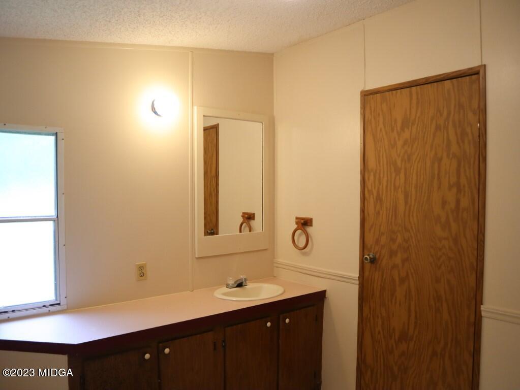 2560 Bonner Gilbert Road Lizella, GA 31052 - Photo 13 of 23 a bathroom with a sink and a mirror