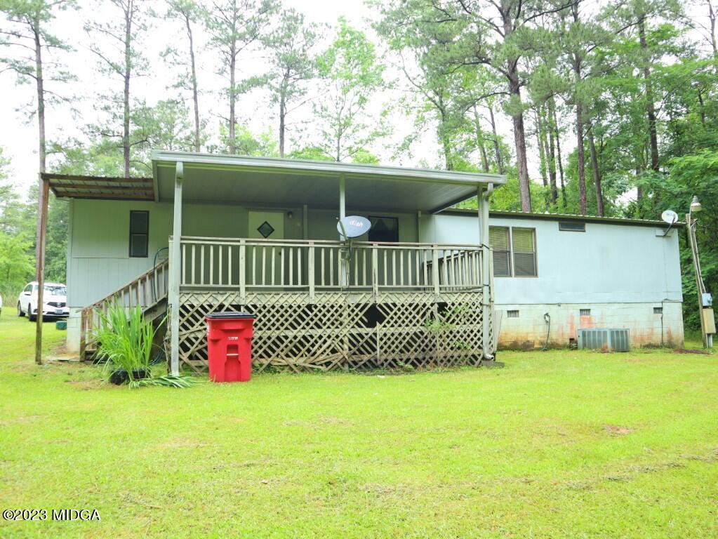 2560 Bonner Gilbert Road Lizella, GA 31052 - Photo 22 of 23 a front view of a house with a garden and deck