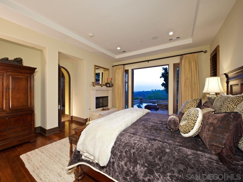 18668 Via Catania Rancho Santa Fe, CA 92091 - Photo 11 of 25 a spacious bedroom with a large bed and a dresser