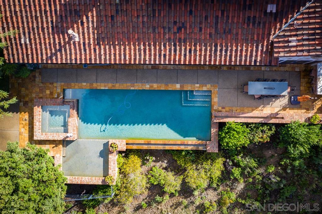 18668 Via Catania Rancho Santa Fe, CA 92091 - Photo 17 of 25 a view of a patio with table and chairs with wooden fence