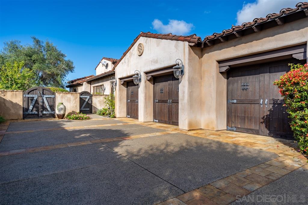18668 Via Catania Rancho Santa Fe, CA 92091 - Photo 19 of 25 a view of a white house with a street
