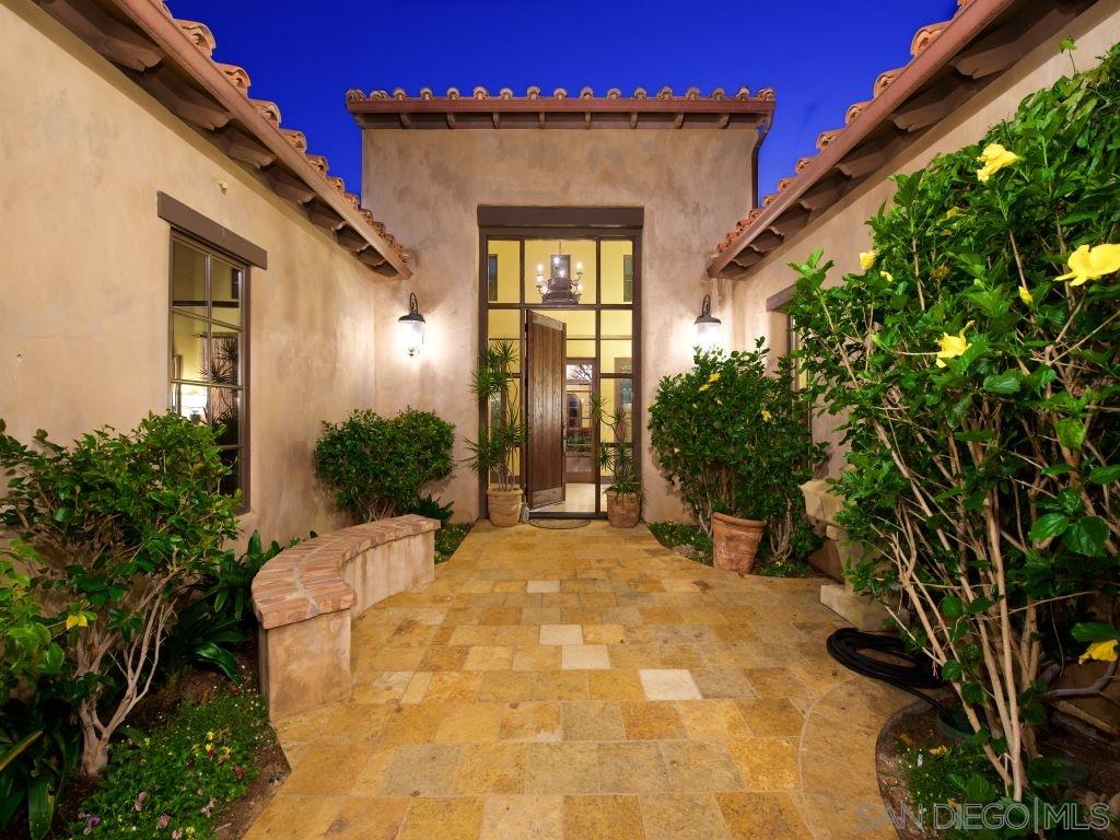 18668 Via Catania Rancho Santa Fe, CA 92091 - Photo 3 of 25 a view of a house with a small yard