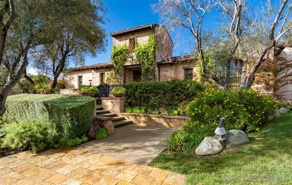 18668 Via Catania Rancho Santa Fe, CA 92091 - Photo 4 of 25 a front view of a house with a garden