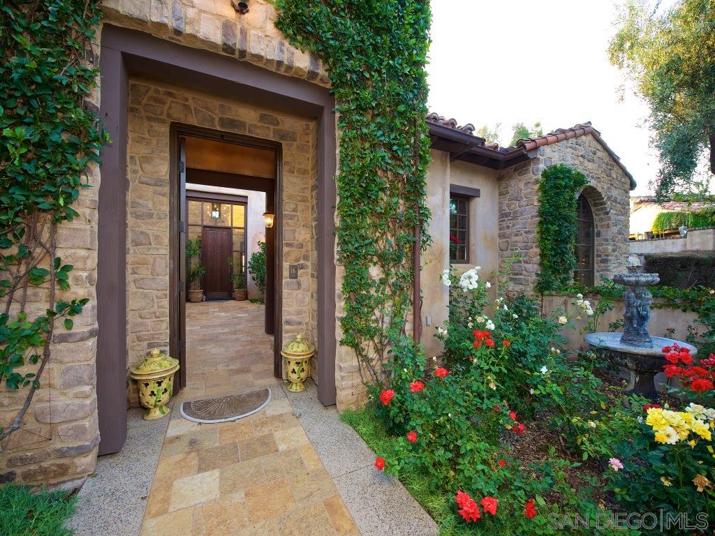 18668 Via Catania Rancho Santa Fe, CA 92091 - Photo 6 of 25 a backyard of a house with flower plants