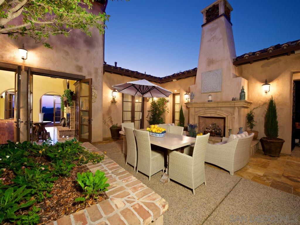 18668 Via Catania Rancho Santa Fe, CA 92091 - Photo 7 of 25 a living room with fireplace furniture and a potted plant