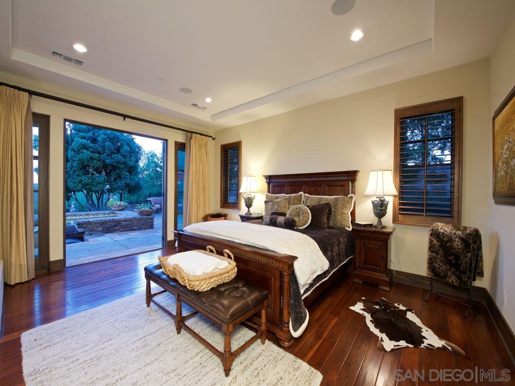 18668 Via Catania Rancho Santa Fe, CA 92091 - Photo 10 of 25 a bedroom with a bed and wooden floor