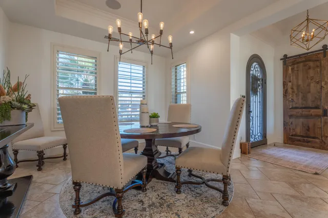 a bedroom with furniture and a large window