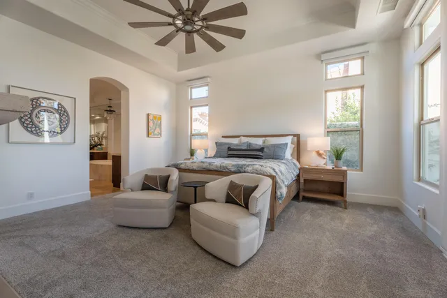 a bedroom with a bed and a chandelier