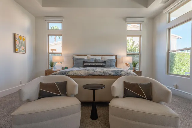 a bedroom with a bed and a mirror