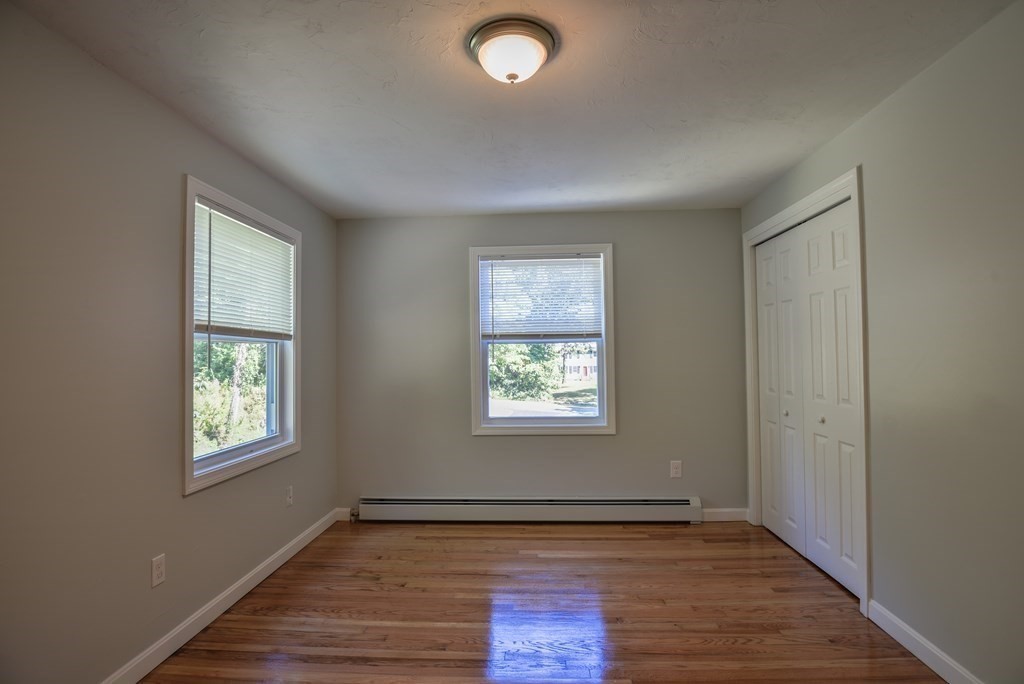 1 Ladd Road Sturbridge, MA 01566 - Photo 34 of 39 a view of an empty room with wooden floor and a window