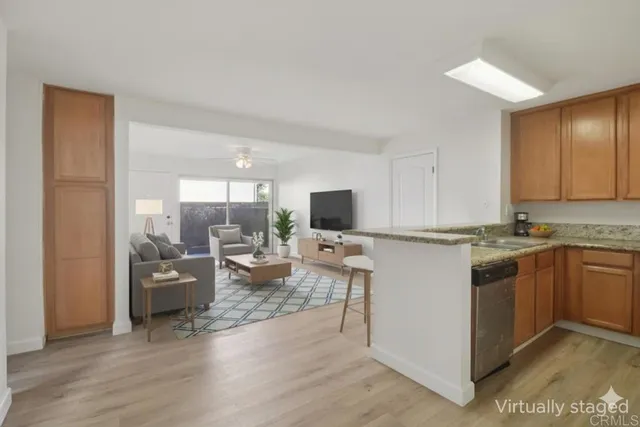 a view of living room with kitchen island furniture and wooden floor