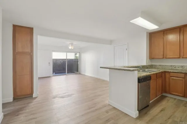 a kitchen with granite countertop a stove and cabinets