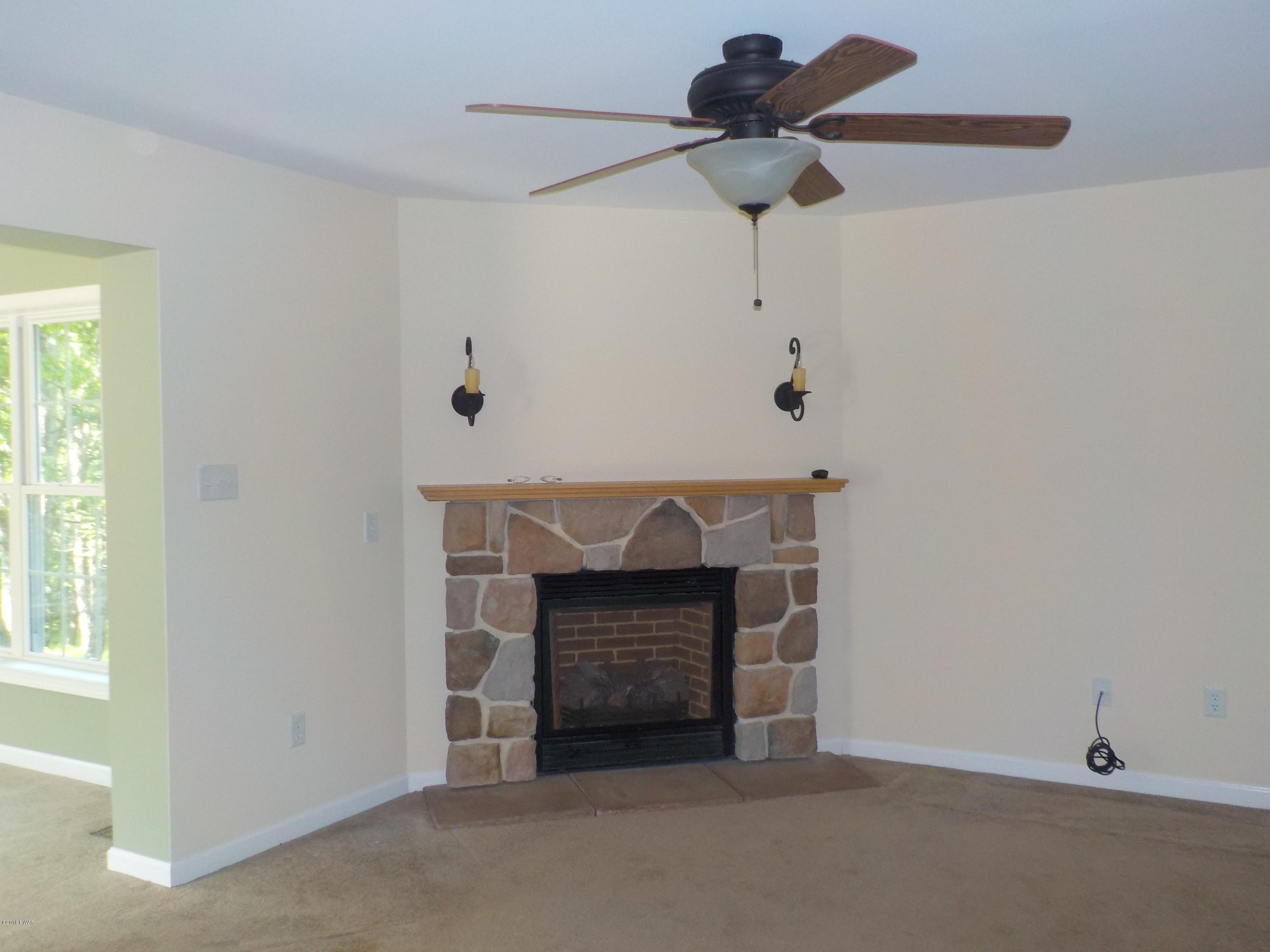 230 Maple Ridge Drive Hawley, PA 18428 - Photo 19 of 35 a living room with furniture and a fireplace